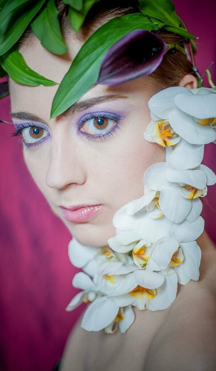 Photographe portrait avec des fleurs en studio